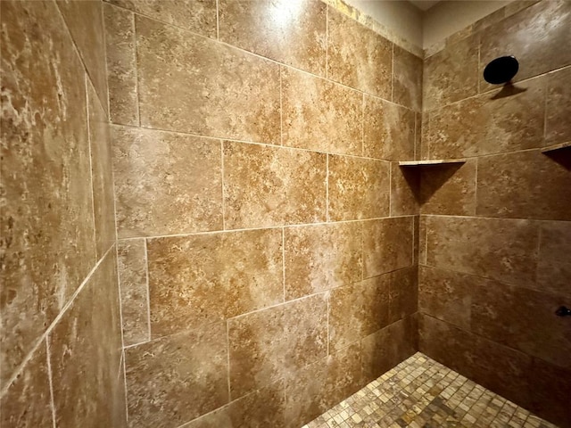 interior details with a tile shower