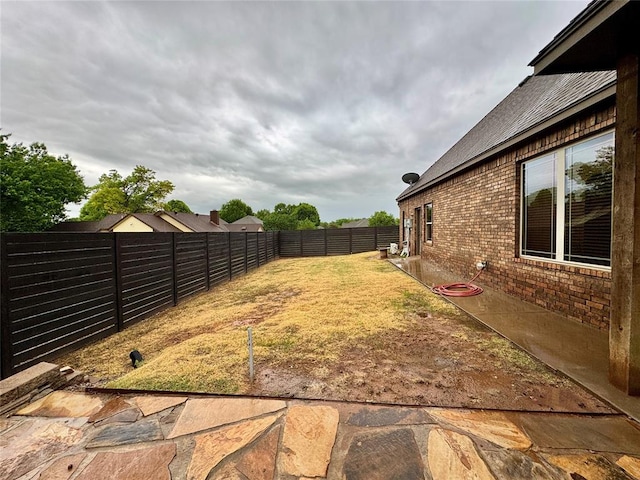 view of yard with a fenced backyard