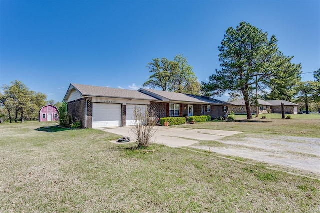 ranch-style home featuring a garage, brick siding, a front yard, and concrete driveway