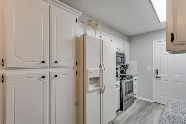 kitchen featuring light countertops, black microwave, white fridge with ice dispenser, light wood-style flooring, and stainless steel range with electric stovetop