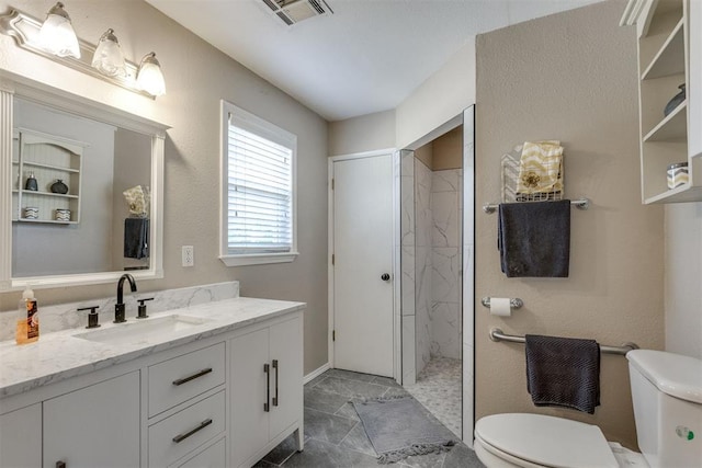 full bath featuring toilet, vanity, visible vents, and tiled shower
