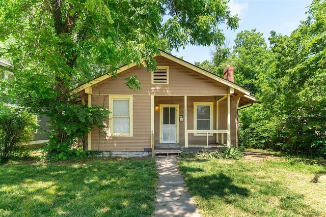 912 Classen Blvd, Norman, OK 73071 - bungalow-style house featuring a porch, a front lawn, and a chimney