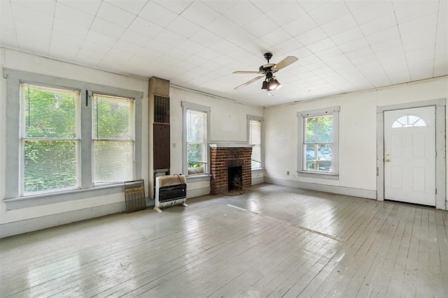 912 Classen Blvd, Norman, OK 73071 - unfurnished living room with heating unit, hardwood / wood-style floors, ceiling fan, and a fireplace
