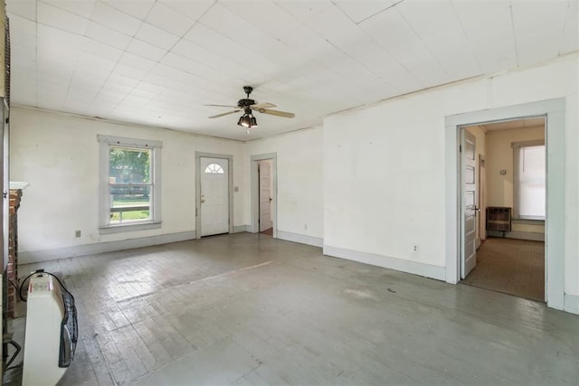 912 Classen Blvd, Norman, OK 73071 - unfurnished living room with ceiling fan and baseboards