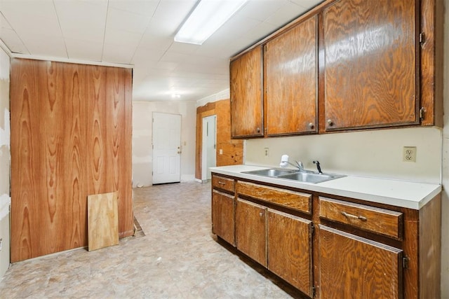 912 Classen Blvd, Norman, OK 73071 - kitchen with a sink, light countertops, brown cabinetry, and light floors