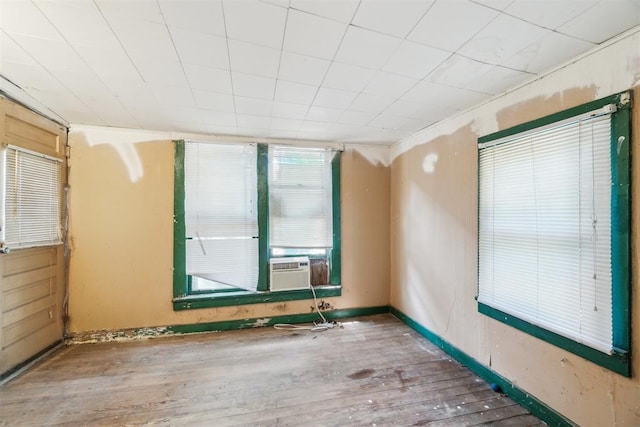 912 Classen Blvd, Norman, OK 73071 - unfurnished room featuring wood finished floors and cooling unit
