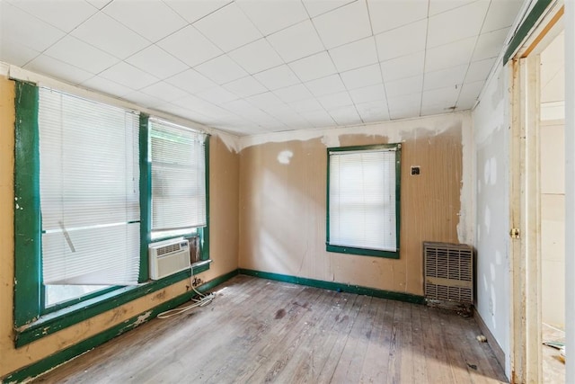 912 Classen Blvd, Norman, OK 73071 - unfurnished room featuring wood-type flooring, cooling unit, heating unit, and baseboards
