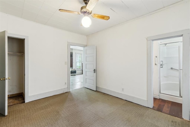 912 Classen Blvd, Norman, OK 73071 - unfurnished bedroom with a closet, baseboards, ensuite bathroom, ceiling fan, and carpet