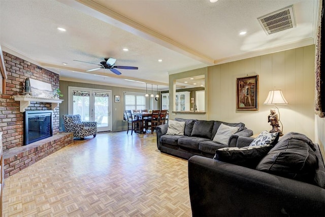 living room featuring recessed lighting, ceiling fan, visible vents, a textured ceiling, and crown molding