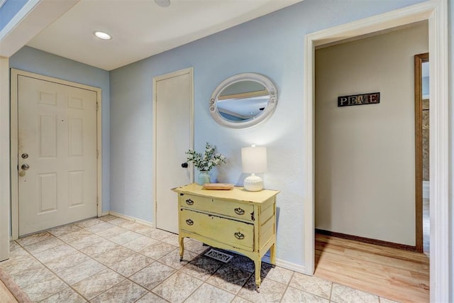 foyer with light tile patterned floors, recessed lighting, and baseboards