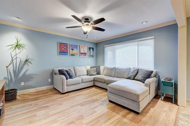 living area with baseboards, ceiling fan, crown molding, and light wood finished floors