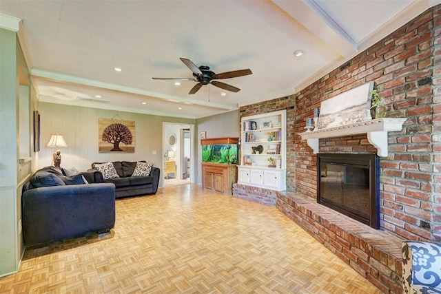 living area with a ceiling fan, crown molding, and a brick fireplace