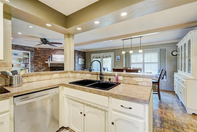 kitchen featuring glass insert cabinets, a sink, ceiling fan, dishwasher, and recessed lighting