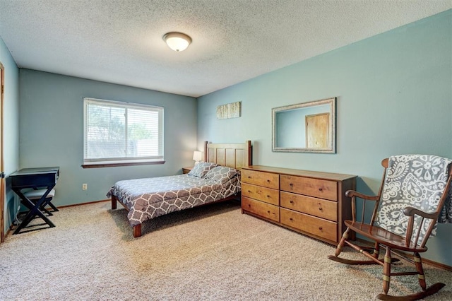 bedroom with baseboards, a textured ceiling, and carpet flooring