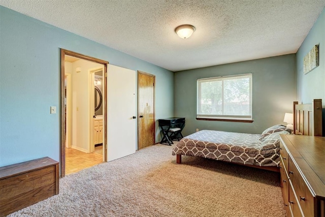 bedroom featuring a textured ceiling and light carpet
