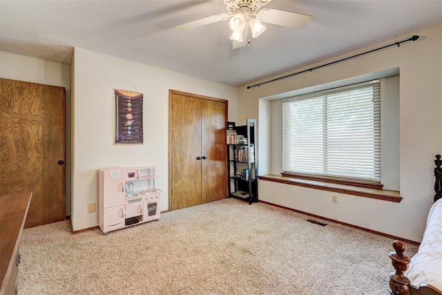 bedroom featuring visible vents, a closet, baseboards, and carpet floors