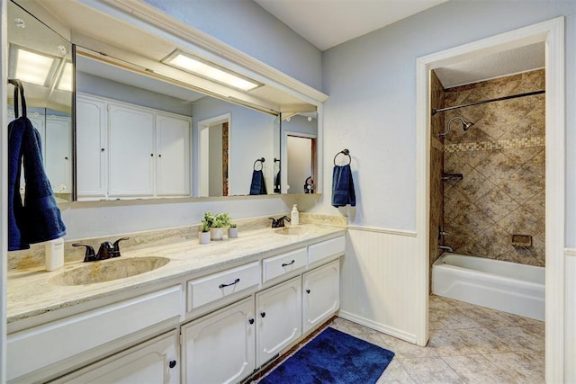 bathroom with  shower combination, tile patterned flooring, double vanity, and a sink