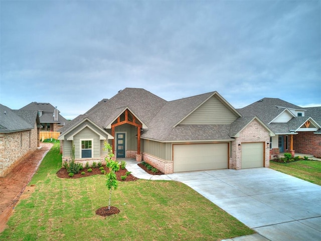 1715 Zayden Ln, Norman, OK 73072 - view of front facade featuring concrete driveway, a shingled roof, a front yard, an attached garage, and brick siding