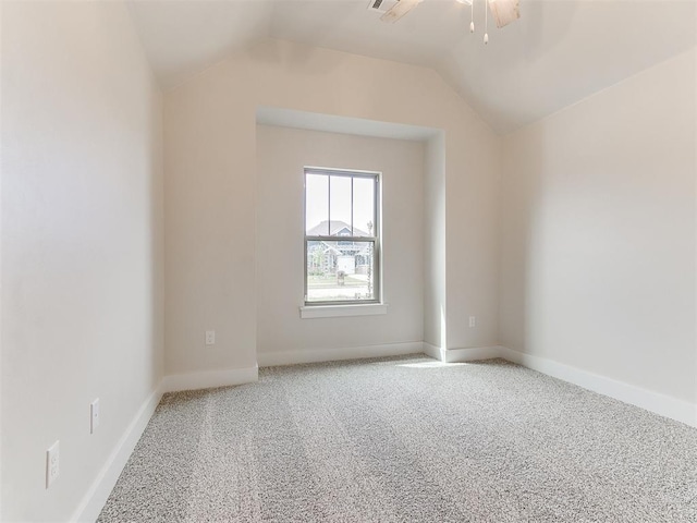 1715 Zayden Ln, Norman, OK 73072 - unfurnished room featuring a ceiling fan, carpet flooring, vaulted ceiling, and baseboards