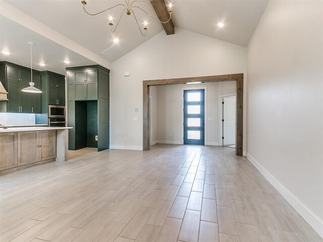 1715 Zayden Ln, Norman, OK 73072 - unfurnished living room with baseboards, an inviting chandelier, light wood-style flooring, beam ceiling, and high vaulted ceiling