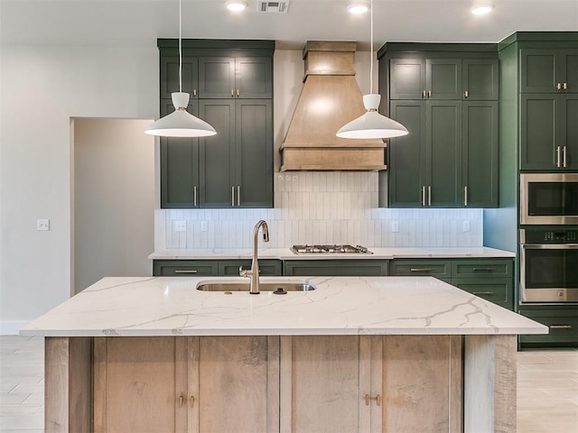 1715 Zayden Ln, Norman, OK 73072 - kitchen featuring decorative backsplash, stainless steel appliances, green cabinets, a sink, and premium range hood