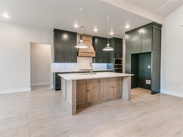1715 Zayden Ln, Norman, OK 73072 - kitchen with stainless steel appliances, light countertops, tasteful backsplash, baseboards, and premium range hood