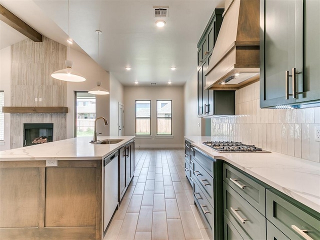 1715 Zayden Ln, Norman, OK 73072 - kitchen with green cabinetry, tasteful backsplash, premium range hood, and a sink