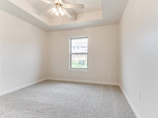 1715 Zayden Ln, Norman, OK 73072 - spare room with a raised ceiling, ceiling fan, carpet flooring, and baseboards