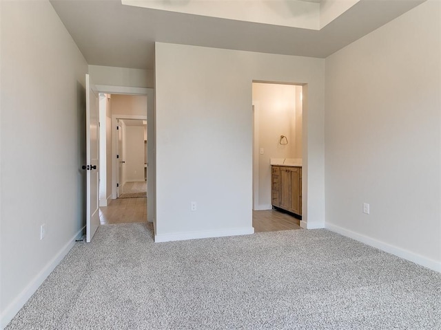 1715 Zayden Ln, Norman, OK 73072 - unfurnished bedroom with light colored carpet, connected bathroom, and baseboards