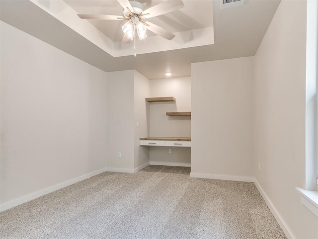 1715 Zayden Ln, Norman, OK 73072 - unfurnished room with carpet flooring, a raised ceiling, a ceiling fan, and built in study area