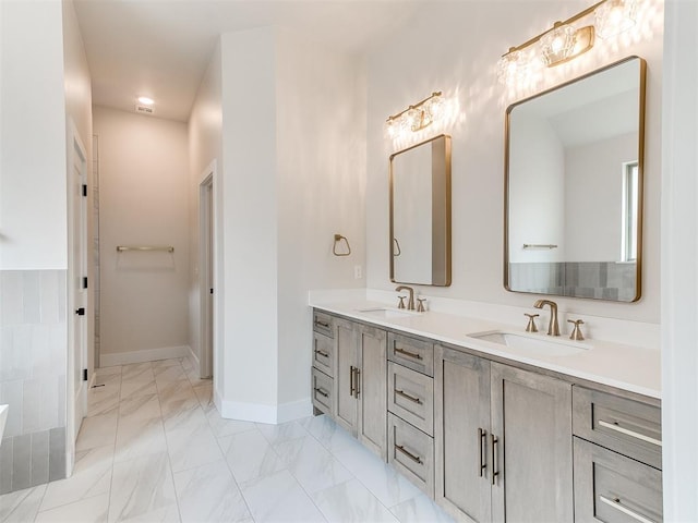 1715 Zayden Ln, Norman, OK 73072 - bathroom featuring double vanity, baseboards, marble finish floor, and a sink
