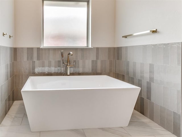 1715 Zayden Ln, Norman, OK 73072 - full bath featuring tile walls, wainscoting, and a freestanding bath