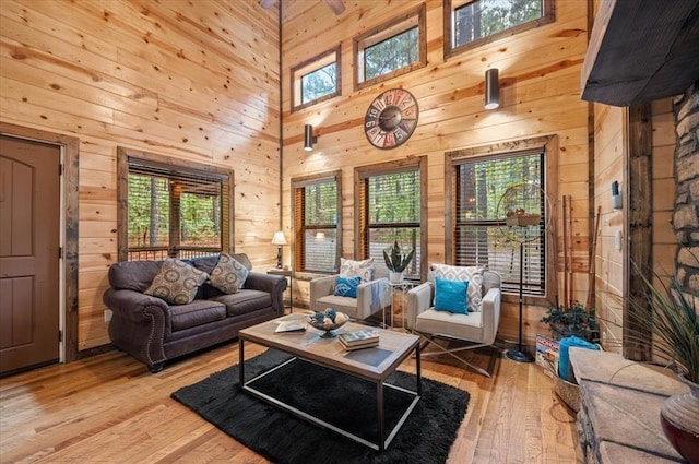88 Bent Pine Trl, Broken Bow, OK 74728 - living area with wooden walls, a high ceiling, and light wood finished floors