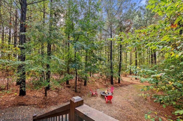 88 Bent Pine Trl, Broken Bow, OK 74728 - view of yard with a forest view and an outdoor fire pit