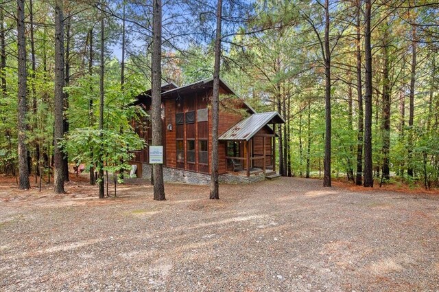 88 Bent Pine Trl, Broken Bow, OK 74728 - view of front of house featuring driveway and metal roof