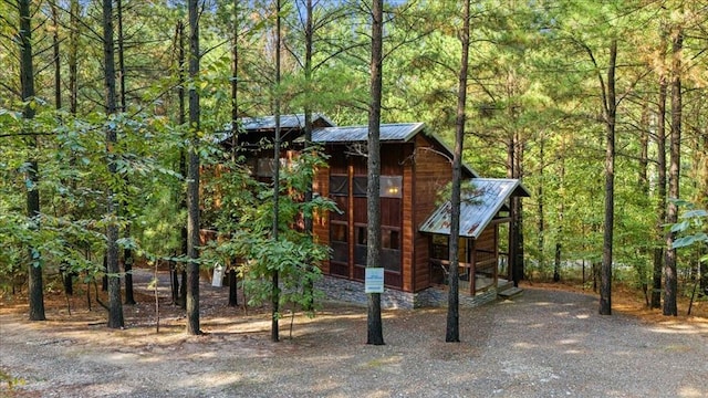 88 Bent Pine Trl, Broken Bow, OK 74728 - view of front facade featuring a view of trees and metal roof