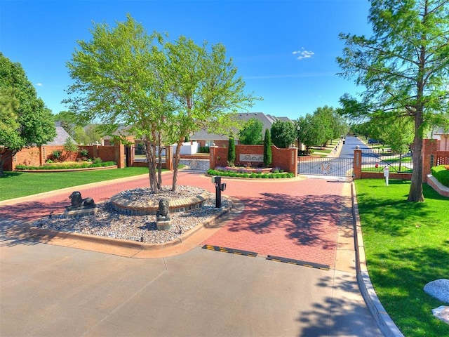 surrounding community featuring a gate, a lawn, and fence