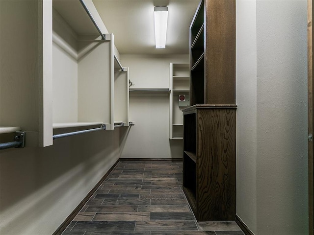 walk in closet featuring dark wood-type flooring