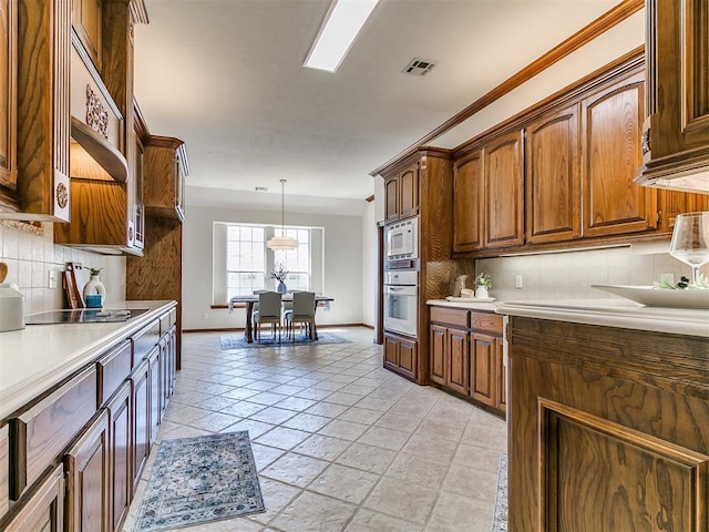 kitchen with built in microwave, visible vents, baseboards, decorative backsplash, and white oven