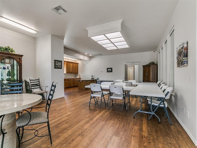 dining room with baseboards, dark wood-style flooring, and visible vents