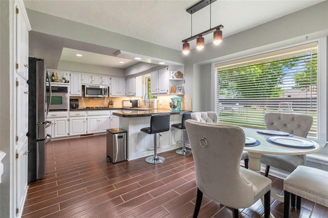 dining space featuring dark wood-type flooring and a wealth of natural light