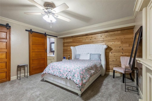 bedroom featuring carpet floors, a barn door, crown molding, and wood walls