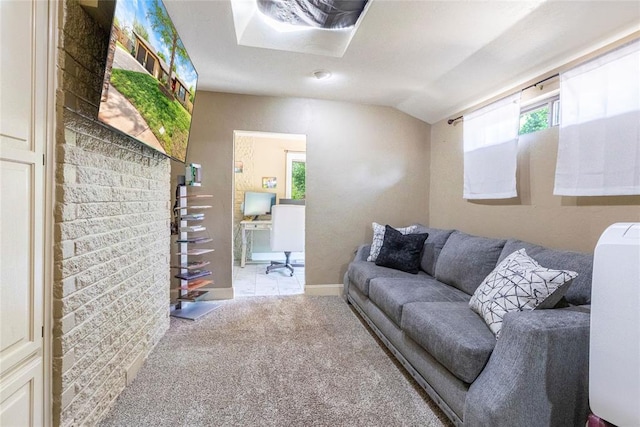carpeted living area with baseboards and lofted ceiling