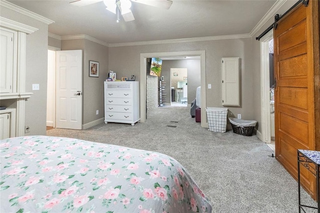 bedroom with crown molding, light colored carpet, a barn door, multiple windows, and a ceiling fan
