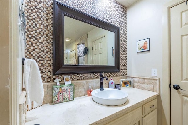 bathroom with vanity and decorative backsplash