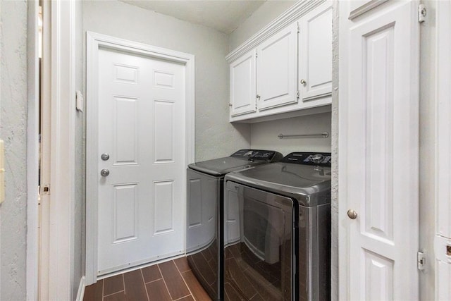 laundry room with independent washer and dryer, wood tiled floor, and cabinet space