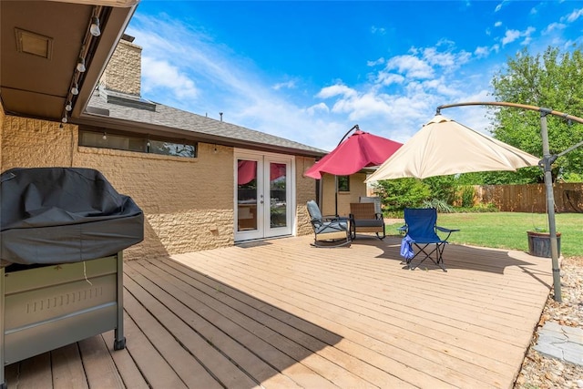 wooden deck with a yard, french doors, and fence