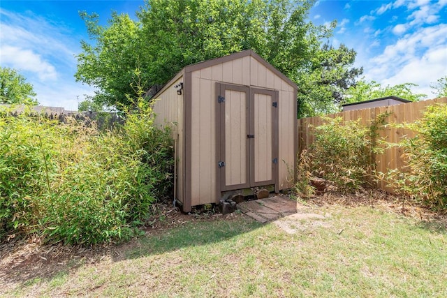 view of shed featuring fence