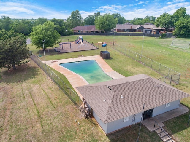 exterior space featuring a lawn, central AC, fence, and a fenced in pool