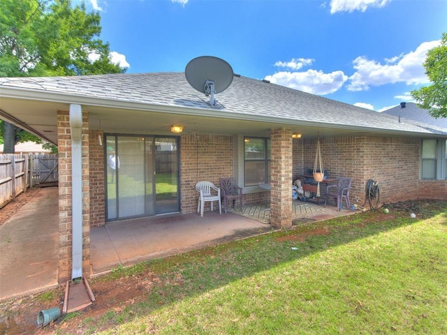 1717 Park View Pl, Edmond, OK 73003 - rear view of property featuring brick siding, a patio area, and roof with shingles
